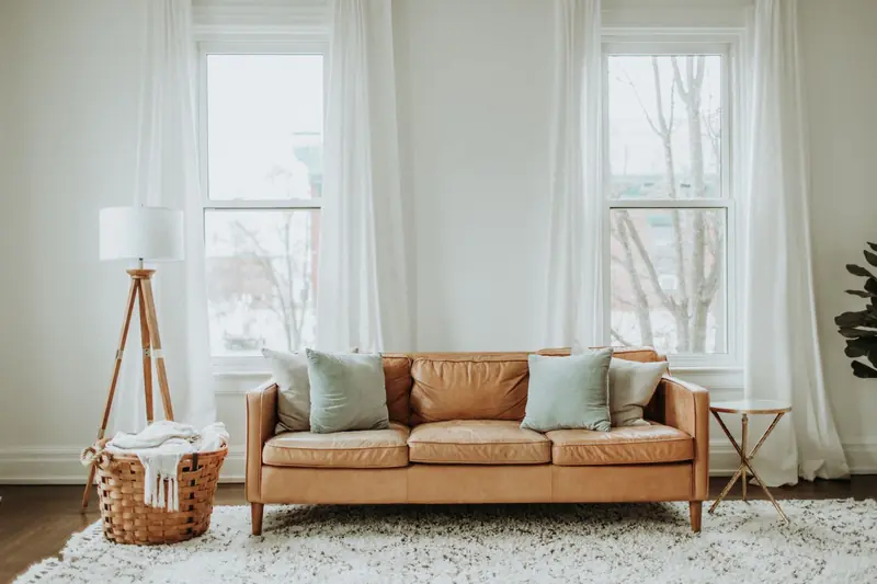 A cozy minimalist living room with a leather sofa and stylish decor